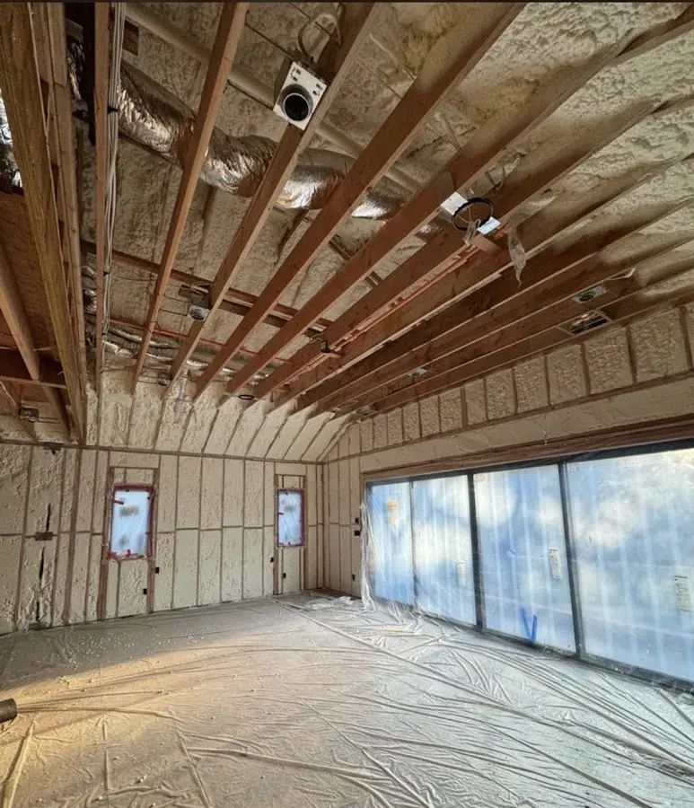 Interior walls and ceiling insulated with spray foam during new construction in Earlimart